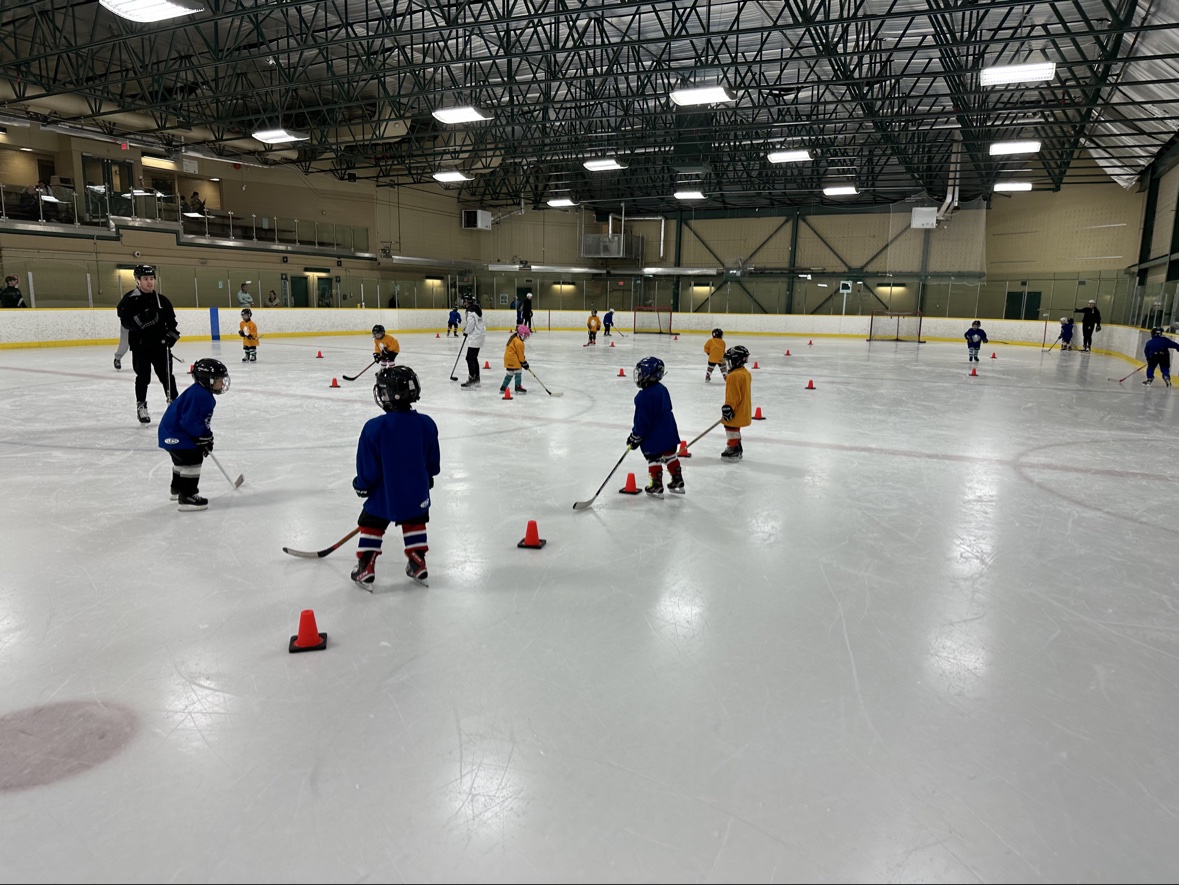 Young hockey players taking part in a structured on-ice session