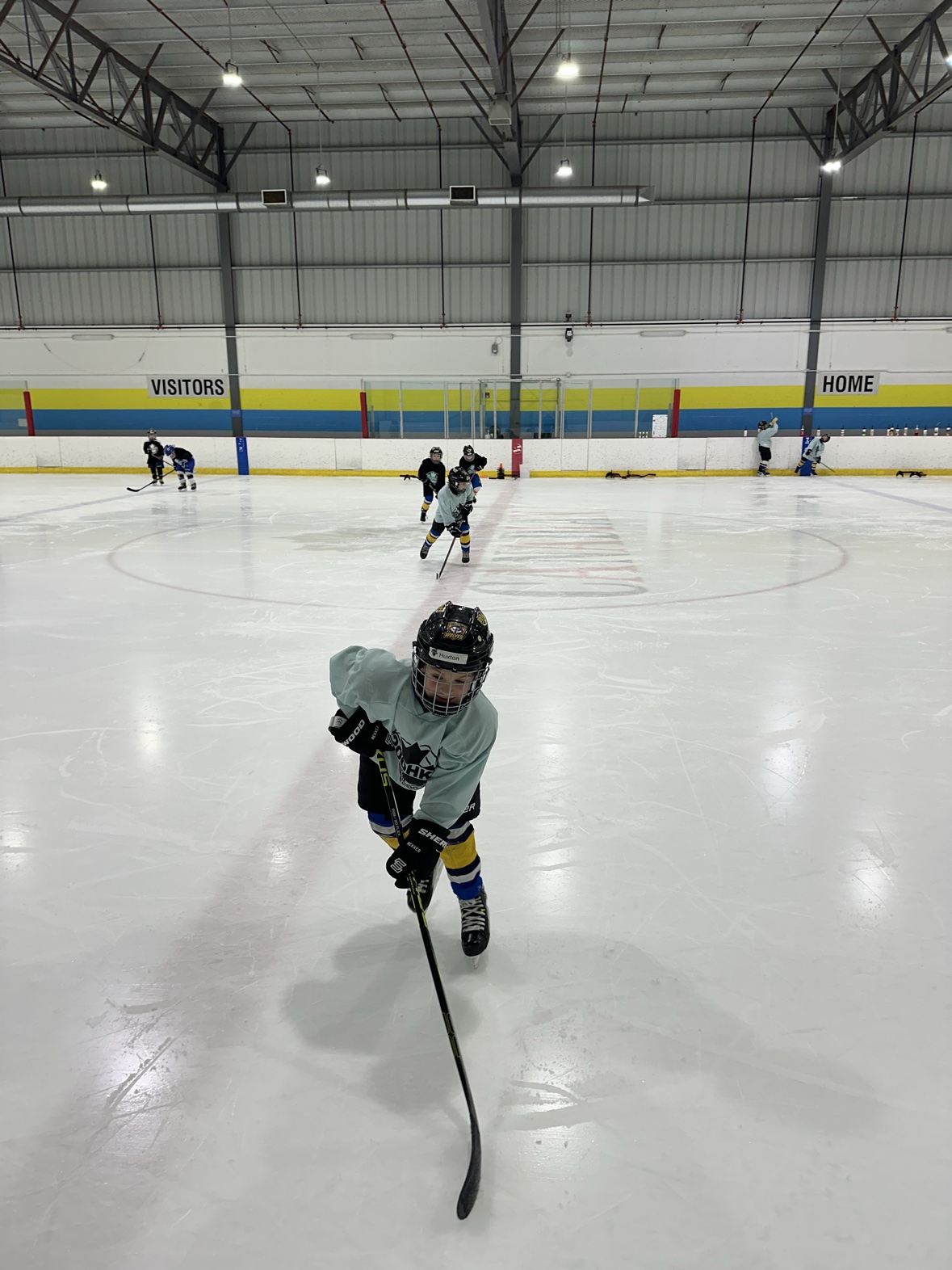 Young hockey player skating toward the camera during a drill