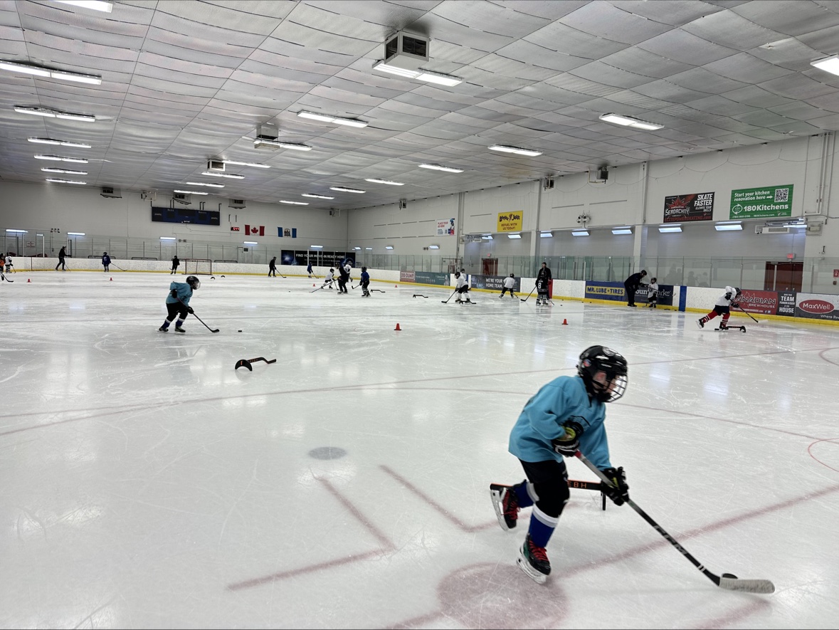 Young hockey players training together across the ice
